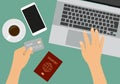 Flat design illustration of hands holding a credit card. Laptop and passport on table with cup of coffee and smartphone, vector Royalty Free Stock Photo