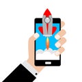 Businessman holding a smartphone with a rocket.Concept of Start up. Royalty Free Stock Photo