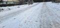 A flat field covered with deep snow and a person\'s footprints