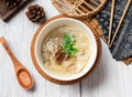 flat food soup in a dish with wooden soup isolated on wood table side view taiwan food