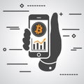 Hand showing phone with bitcoin graph going up