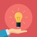 Flat Illustration of a Hand Holding Light Bulb Royalty Free Stock Photo