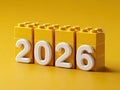 Flat image featuring six yellow Lego bricks with white numerals 2026, arranged linearly against a uniform yellow background Royalty Free Stock Photo