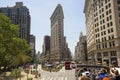 Flat Iron building facade with tourists in bus. New York, USA