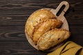 Flat la of baked meat turnovers or pies, or empanadas, or cornish pasty