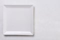 Flat lay above white square plate on the white marble background table Royalty Free Stock Photo