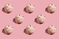 Flat lay abstract pattern with ceramic pink piggy bank on pink background. Top view. Finance or banking concept