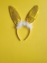 Flat lay accessory costume bunny ears on beautiful yellow background at home office desk. Creative concept of happy Easter. Royalty Free Stock Photo
