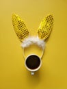 Flat lay accessory costume bunny ears on beautiful yellow background at home office desk. Creative concept of happy Easter. Royalty Free Stock Photo