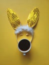 Flat lay accessory costume bunny ears on beautiful yellow background at home office desk. Creative concept of happy Easter. Royalty Free Stock Photo