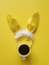 Flat lay accessory costume bunny ears on beautiful yellow background at home office desk. Creative concept of happy Easter. Royalty Free Stock Photo