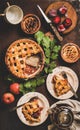 Flat-lay of apple and plum pie on rack with tea