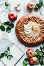 flat lay with arranged homemade apple pie, empty notebook, fresh apples and green leaves Royalty Free Stock Photo