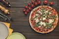 Flat lay with arranged italian pizza, cutlery andcherry tomatoes Royalty Free Stock Photo