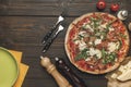 Flat lay with arranged italian pizza, cutlery and various ingredients Royalty Free Stock Photo