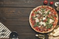 Flat lay with arranged italian pizza, cutlery and various ingredients Royalty Free Stock Photo