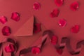 flat lay with arranged red roses petals envelope and ribbon Royalty Free Stock Photo