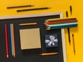Flat lay art accessories on yellow background with blank space f