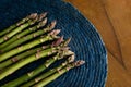 Flat lay asparagus blue and wooden textures on background