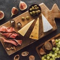 flat lay with assorted cheese jamon and fruits