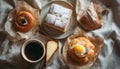 Flat Lay of Assorted Pastries with Coffee and Napkin on White Background Royalty Free Stock Photo
