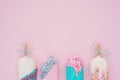 Flat lay assorted pop ice cream cones on modern pink paper wallpaper.