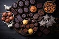 flat lay of an assortment of chocolates on a dark wooden table