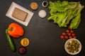 Flat lay. Assortment. Ingredients for vegan greek salad on black background. Copy space