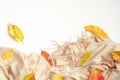 Flat lay autumn composition with beige fabric and fallen leaves. Top view, overhead. Autumn background concept