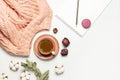 Flat lay autumn composition. Cup of coffee pink knitted women`s sweater or warm plaid cotton flowers dry rose eucalyptus macaroon Royalty Free Stock Photo