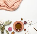 Flat lay autumn composition. Cup of coffee pink knitted women`s sweater or warm plaid cotton flowers dry rose eucalyptus macaroon Royalty Free Stock Photo