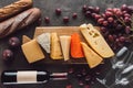 flat lay with baguettes assorted cheese bottle of wine and fruits