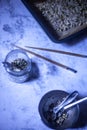 Preparation of a healthy vegan multi-seed mix recipe with ingredients and kitchen tools laid out on a grey concrete countertop