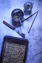 Preparation of a healthy vegan multi-seed mix recipe with ingredients and kitchen tools laid out on a grey concrete countertop