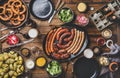 Flat-lay of Bavarian Octoberfest dinner with beers and meat sausages Royalty Free Stock Photo