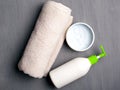 Flat lay beautiful spa composition cream and toweln on gray background. hygiene and skin care accessories