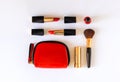 Lat lay of beauty cosmetic make up products in red, black and gold color knolled on white background. Royalty Free Stock Photo
