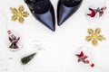 Flat lay black high heel shoes, mini christmas tree and Christmas ornaments on grunge white wood background, Merry Christmas and Royalty Free Stock Photo