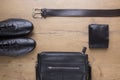 Flat lay of black leather mens accessories