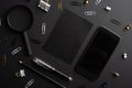 Flat lay, black style.Set of stationery accessories mock up on black background, phone, black card Royalty Free Stock Photo