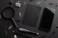 Flat lay, black style.Set of stationery accessories mock up on black background, phone, black card Royalty Free Stock Photo