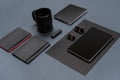 Flat lay of blank black paper sheet, black stationery items and coffee cup on gray desktop. Mock up Royalty Free Stock Photo