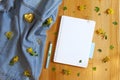 Flat lay of blank notepad, a pen and yellow barberry flowers