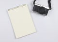 flat lay of blank page opened notebook and camera on white background with copy space. Photo and memory concept Royalty Free Stock Photo