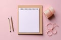 Flat lay blank paper sheet, notebooks, clips pink background. Generative AI