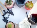 Blank space on white notebook with cactus plants, concrete planters and garden tool set on white background Royalty Free Stock Photo