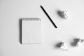 Flat lay of blank white notepad, pencil and crumpled paper on white background Royalty Free Stock Photo