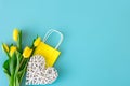 Flat lay blue background with flowers and paper bags. Royalty Free Stock Photo