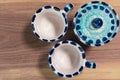 Flat lay of blue small coffee cups and sugar bowl on a wooden elegant background