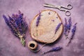 Flat lay a bouquet of purple wildflowers of sage, an empty wooden stump and scissors on a beautiful rustic purple background.